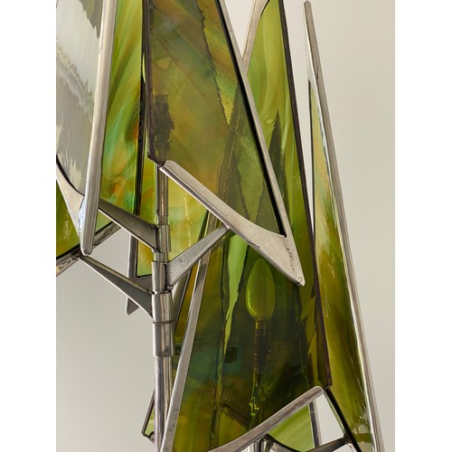 756 - A steel sculpture standard lamp with green glass conical shades and twin stem. 207 h, base width app... 