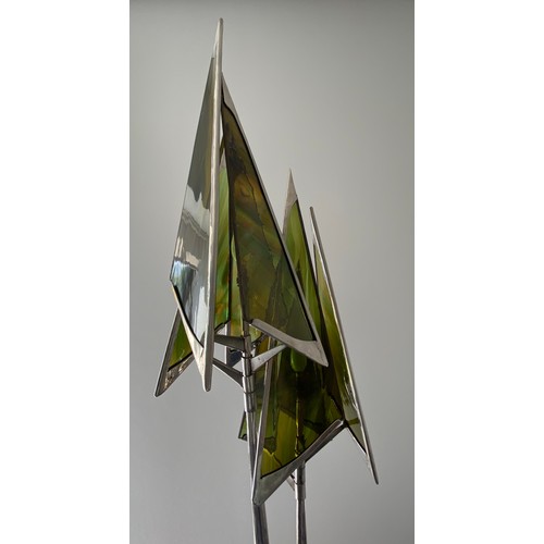 756 - A steel sculpture standard lamp with green glass conical shades and twin stem. 207 h, base width app... 