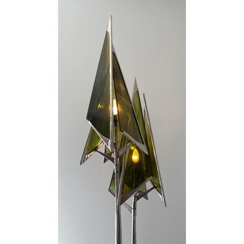 756 - A steel sculpture standard lamp with green glass conical shades and twin stem. 207 h, base width app... 