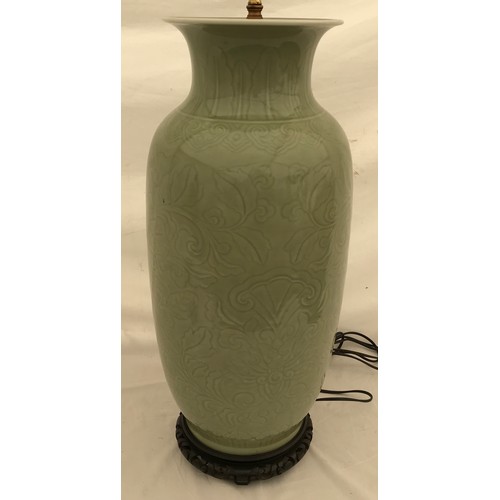 757 - A large Chinese style lamp with green glaze and scroll leaf design. Approx. 88cms h x 28cms w with 4... 