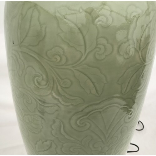 757 - A large Chinese style lamp with green glaze and scroll leaf design. Approx. 88cms h x 28cms w with 4... 