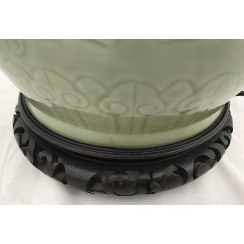 757 - A large Chinese style lamp with green glaze and scroll leaf design. Approx. 88cms h x 28cms w with 4... 