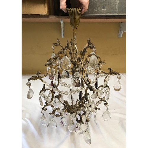 762 - A decorative brass ceiling chandelier with glass droplets, some purple. Approx. 62cms drop.