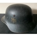 A WWII German helmet with eagle to side and leather liner. Metal interior stamped 4859 and SE64.