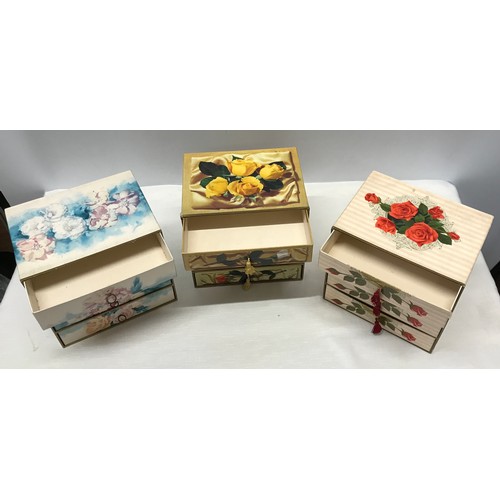 909 - A collection of 3 floral cardboard 4 draw jewellery boxes with decorative design to all 3 and pull t... 