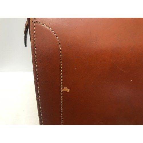 910 - A collection of 3 leather brief cases to include a tan leather Doctors bag opening brief case stampe... 