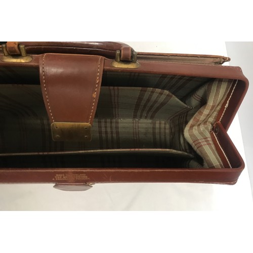 910 - A collection of 3 leather brief cases to include a tan leather Doctors bag opening brief case stampe... 