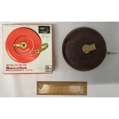 912 - A Swordfish 15m leather measuring tape with original box together with a wooden technical 14cm ruler... 