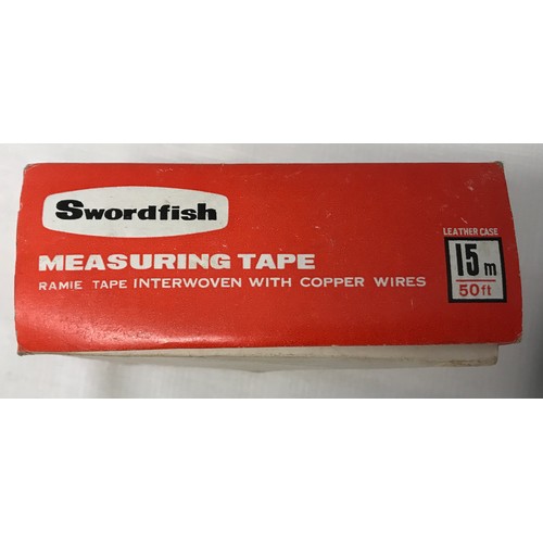 912 - A Swordfish 15m leather measuring tape with original box together with a wooden technical 14cm ruler... 