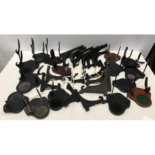 918 - Collection of plate display stands, ebonised wood including cup saucer stands, some wire.