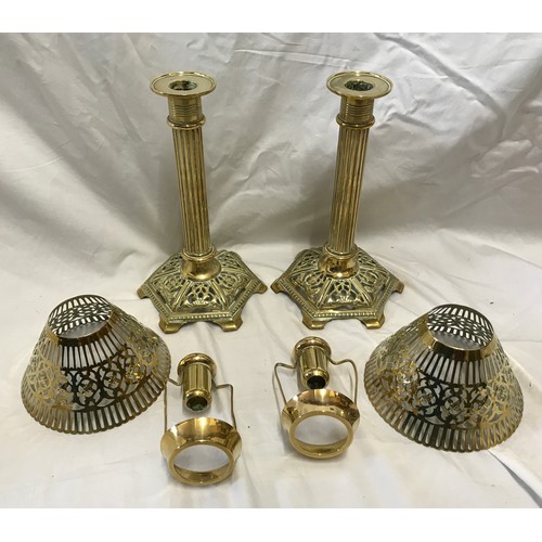 921 - A pair of brass candlesticks with Corinthian columns and decorative pierced shades and base. Approx.... 