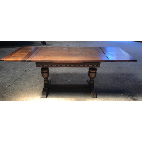 1359 - An oak extending dining table on twin bulbous legs. 77cms w x 122cms. Extends to 199cms.