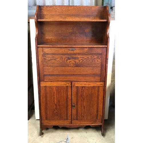 1363 - An oak cabinet with bookshelf top and fold down front with cupboard to the base.
151cms h x 76cms w ... 