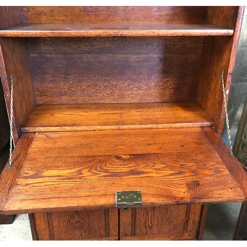 1363 - An oak cabinet with bookshelf top and fold down front with cupboard to the base.
151cms h x 76cms w ... 