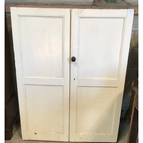 1364 - A painted pine two door cabinet with shelved interior. 136cms h x 102cms w x 41cms d.