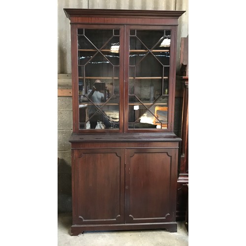 1366 - A mahogany bookcase cabinet with two door glazed panel. 215cms h x 114cms w at cornice x 47cms d.