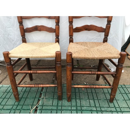 1367 - A set of four rush seated ladderback dining chairs. Height to seat 43cms, height to back 109cms. 42c... 