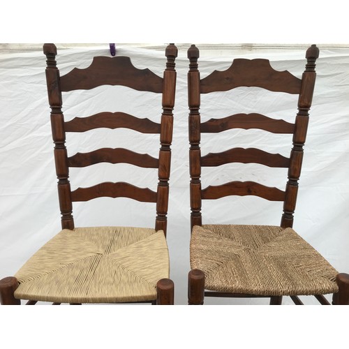 1367 - A set of four rush seated ladderback dining chairs. Height to seat 43cms, height to back 109cms. 42c... 