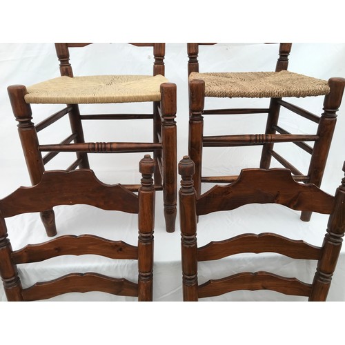 1367 - A set of four rush seated ladderback dining chairs. Height to seat 43cms, height to back 109cms. 42c... 