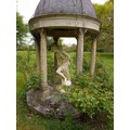 A Bath stone temple with a conical faux lead dome. Inscribed Millennium 2000 with figure of Athena s... 