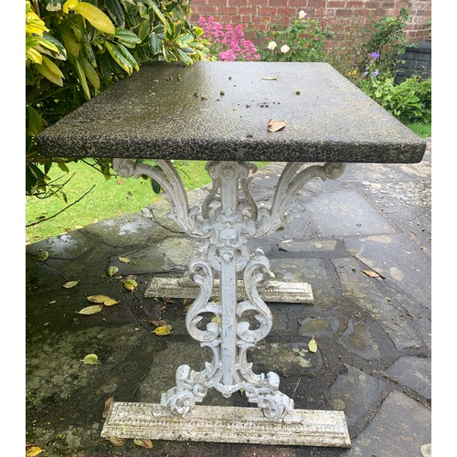 1546 - A cast iron garden table with reconstituted stone top. 76cms w x 51cms d x 73cms h.