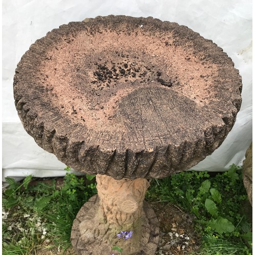 1558 - A reconstituted stone tree trunk bird bath and a terracotta planter. Bird bath 74cms h x 42cms w at ... 