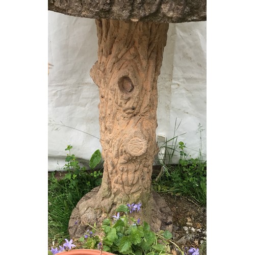 1558 - A reconstituted stone tree trunk bird bath and a terracotta planter. Bird bath 74cms h x 42cms w at ... 