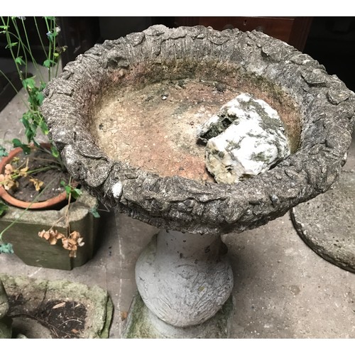 1565 - Three garden ornaments to include concrete bird bath 73cms h, planter 30cms h and a figure with a fl... 