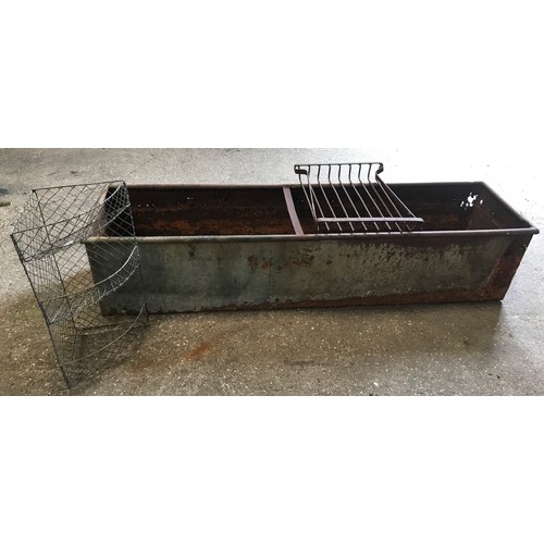 1568 - A large galvanised metal trough 186cms l x 49cms w x 40cms h together with a wire mesh corner shelf ... 