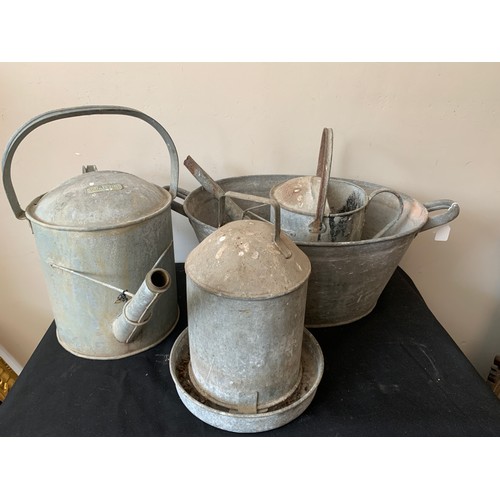 1570 - A quantity of galvanised metal ware to include twin handled tub, 2 watering cans and a chicken feede... 