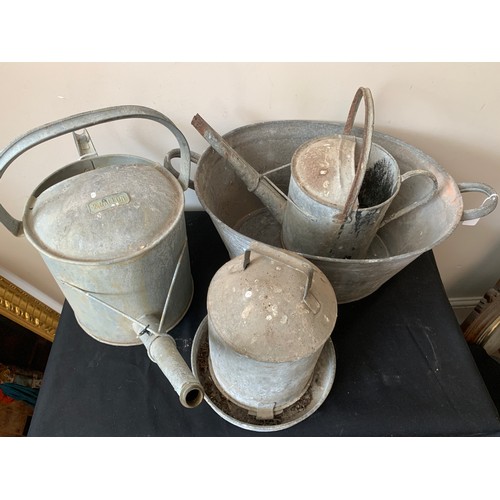 1570 - A quantity of galvanised metal ware to include twin handled tub, 2 watering cans and a chicken feede... 