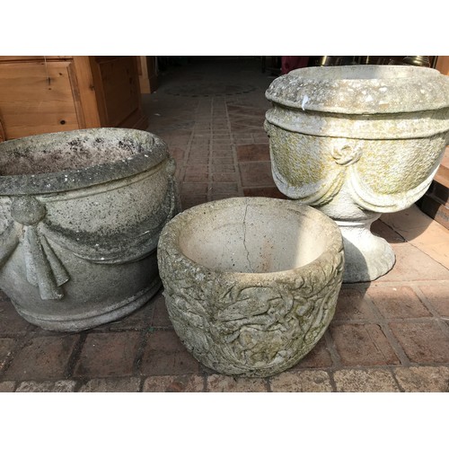 1573 - Three concrete garden planters to include one urn 42cms h x 38cms w, one with swag decoration and a ... 