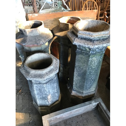 1575 - Seven octagonal chimney pots, one pair 101cms h, three at 94cms h, and small pair 74cms h.