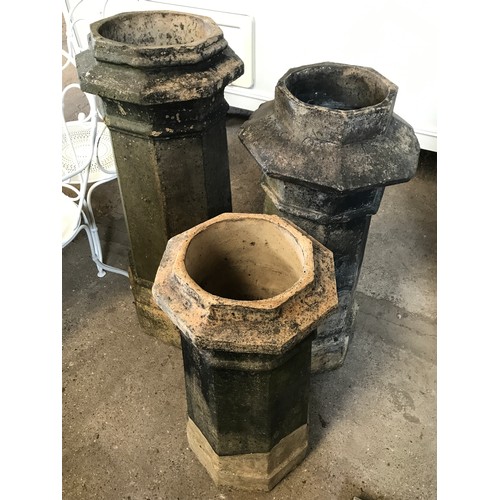 1575 - Seven octagonal chimney pots, one pair 101cms h, three at 94cms h, and small pair 74cms h.