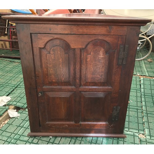 1358 - A Georgian oak corner cupboard, single four panel door, iron hinges. 87 w x 43 d x 94cms h.