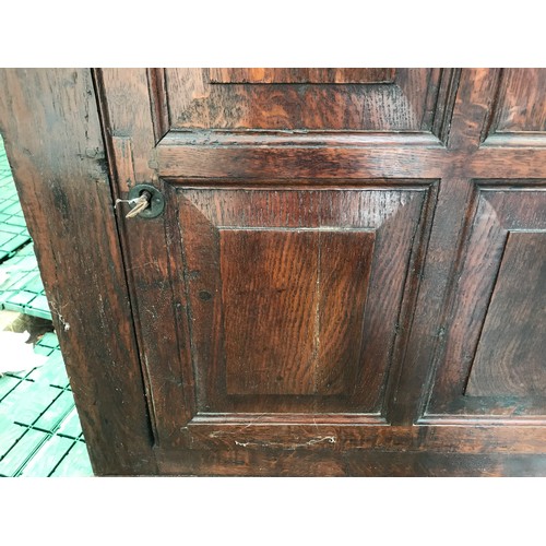 1358 - A Georgian oak corner cupboard, single four panel door, iron hinges. 87 w x 43 d x 94cms h.