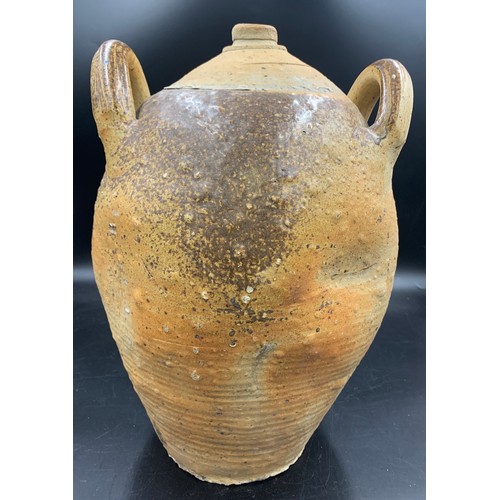 88 - A 19thC French hand thrown stoneware olive oil jug. 42cms h.