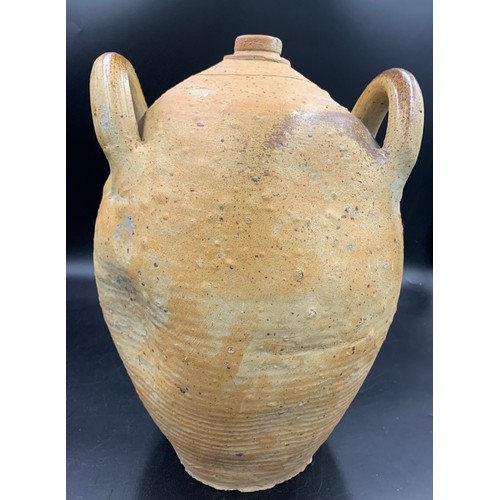 88 - A 19thC French hand thrown stoneware olive oil jug. 42cms h.