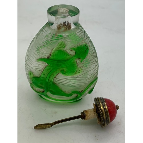 90 - Chinese clear and green glass overlay snuff bottle with dragon decoration. 8cms h.