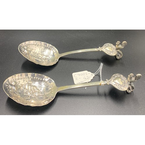 585 - Pair of hand chased Dutch silver spoons with cockerel mounts c1800. They have a sterling silver mark... 