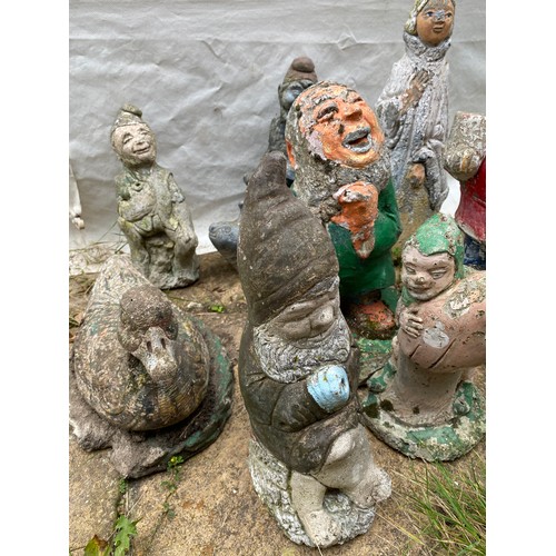 814 - Nine small garden ornaments to include duck, gnomes, seal, lady etc. Tallest 44cms.