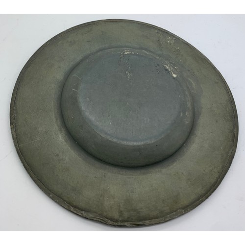 561 - An Arts and Crafts pewter plate with ceramic cabouchons to the border. 15.5cms d.