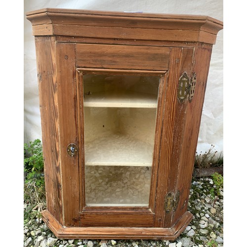 767 - A glazed pine fronted corner cupboard 57cms h x 47cms w. Two shelves to interior.