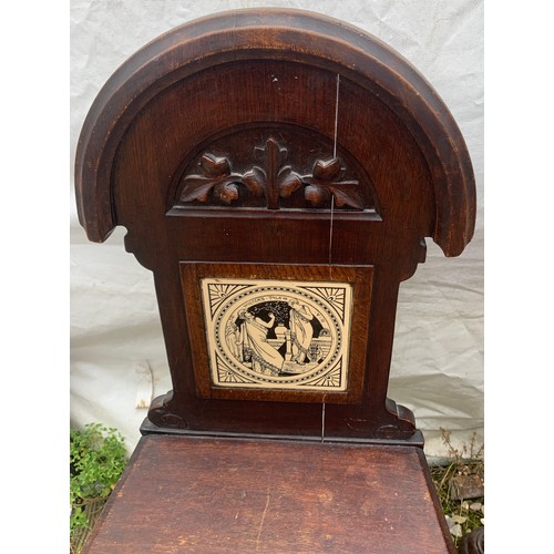 766 - A smokers bow armchair together with a 19thc hall chair with tile to the back.