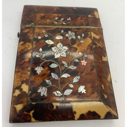 604 - A tortoiseshell and mother of pearl card case. 10.5 x 8cms.