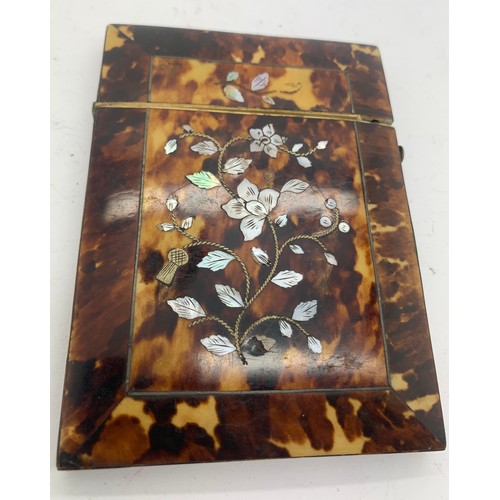 604 - A tortoiseshell and mother of pearl card case. 10.5 x 8cms.