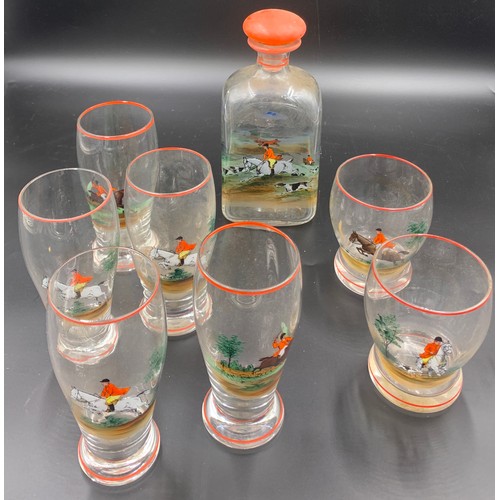 105 - A 1930's enamelled glass decanter and 7 glasses with hunting scenes.