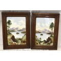 A pair of oak framed hand painted tile plaques of country lake and mountain scenes. Tile size 30.5cm... 