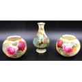 A pair of Royal Worcester bulbous vases 7cms h with rose decoration, one signed 