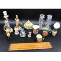 A mixed lot to include a pair of Continental pottery figurine candlesticks 19.5cms h, a small figuri... 